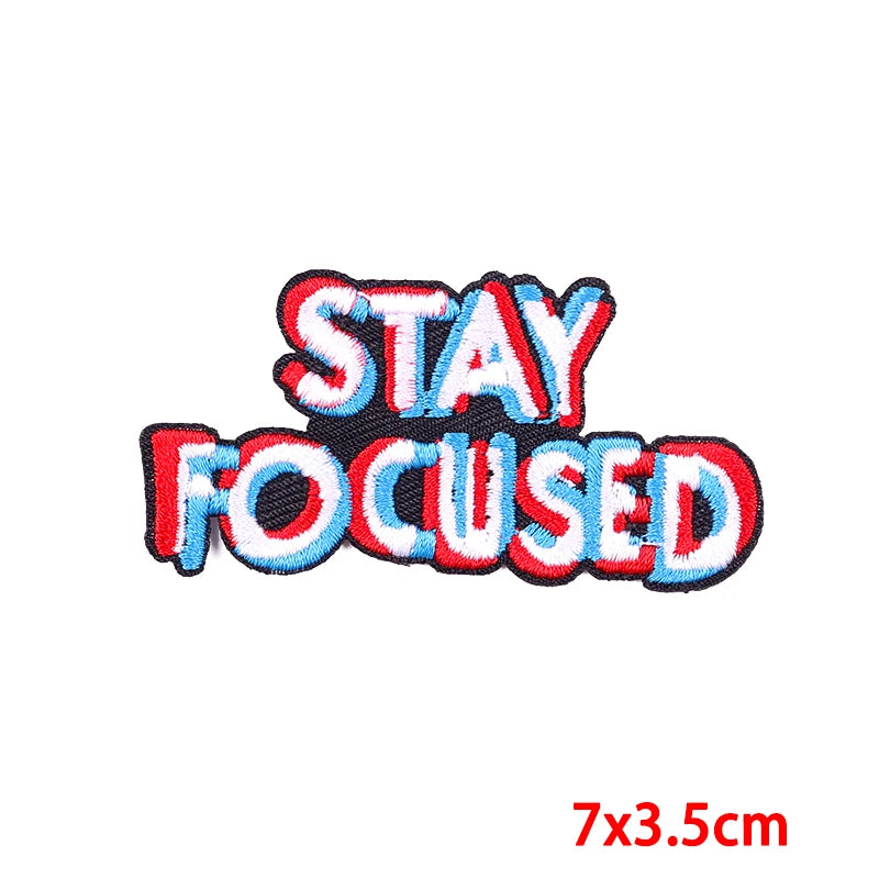 Embroidered patch with 'STAY FOCUSED' text on a white background