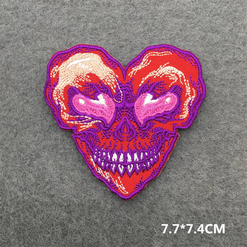 Heart-shaped skull patch with red and purple colors on a gray background