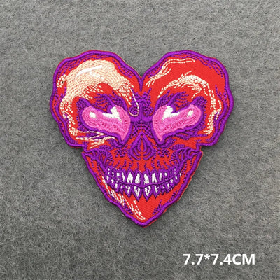 Heart-shaped skull patch with red and purple colors on a gray background