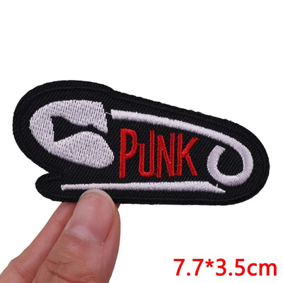 Embroidered patch with 'Punk' text held by a hand on a white background