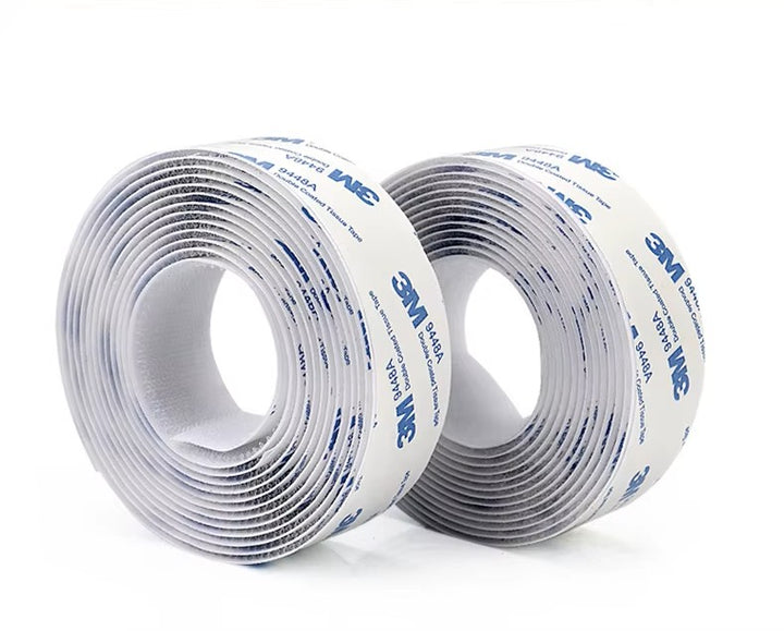 Two rolls of 3M white Velcro tapes on a white background