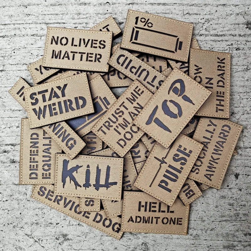 Collection of woven patches with various text on a textured surface