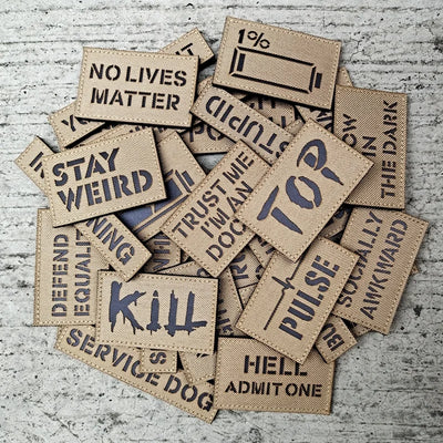 Collection of woven patches with various text on a textured surface