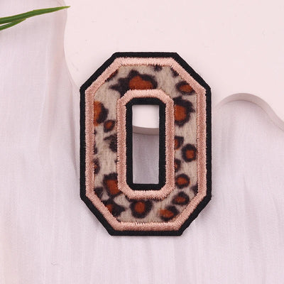 Leopard print number '0' patch on a light pink background