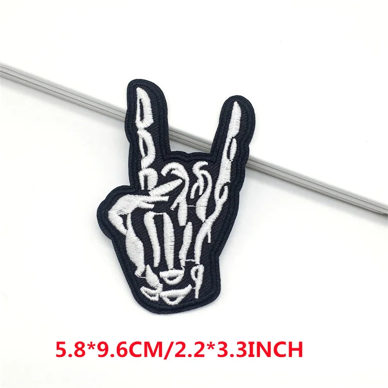 Embroidered patch of a hand making a rock sign on a white background with size text.