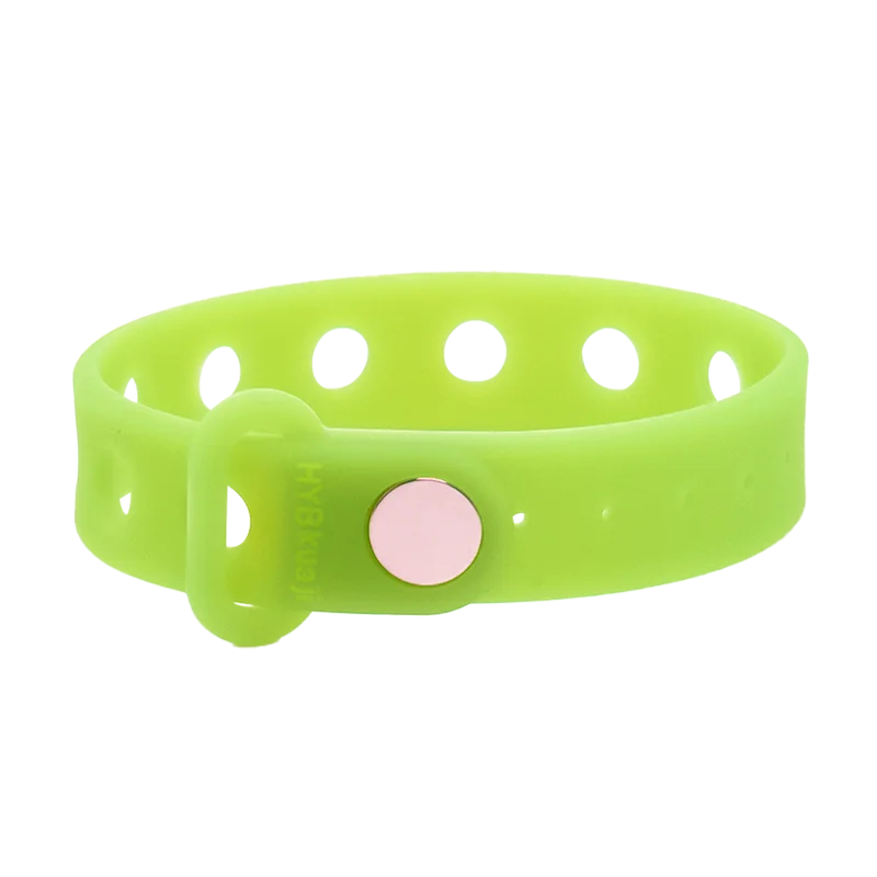 Green wrist band dog collar with a pink button on a white background