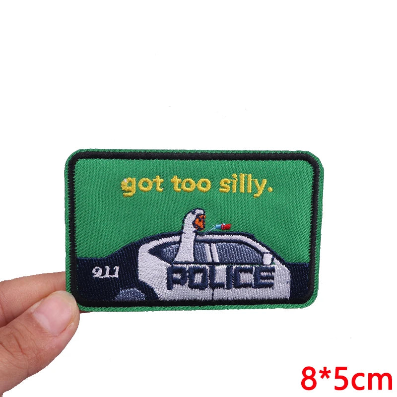 Embroidered patch with a police car and text on a green background