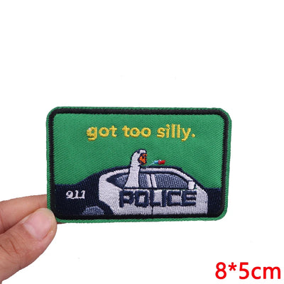 Embroidered patch with a police car and text on a green background