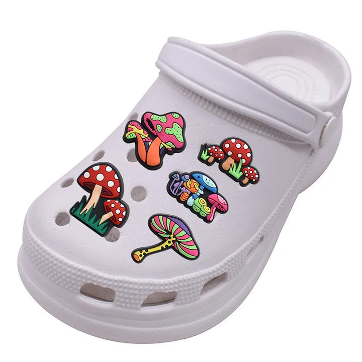 White clog shoe with colorful mushroom shoe pins on a white background