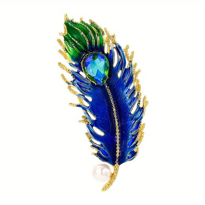 Blue and green peacock feather brooch with gold accents on a white background