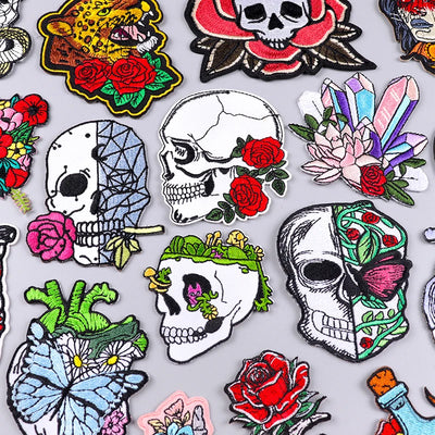 Collection of colorful skull and floral designs on a white background
