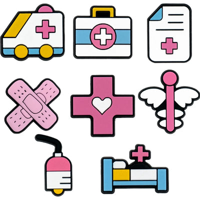 Set of medical shoe charms including an ambulance, first aid kit, bandage, cross, syringe, and hospital bed on a white background.