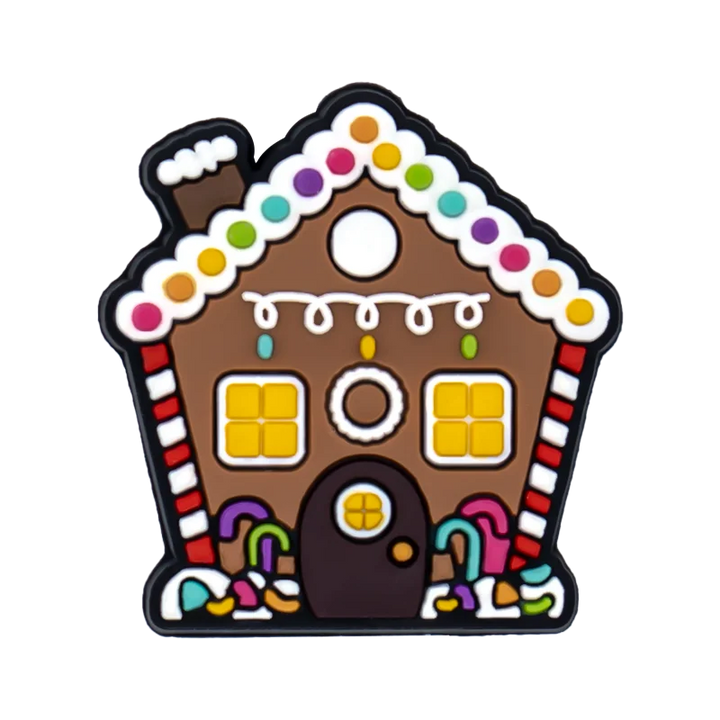Shoe charm ornament of Gingerbread house-shaped cookie with colorful decorations on a white background