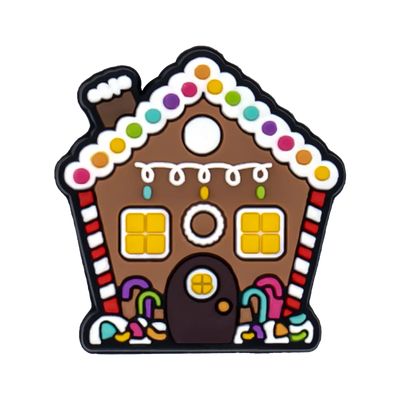 Shoe charm ornament of Gingerbread house-shaped cookie with colorful decorations on a white background