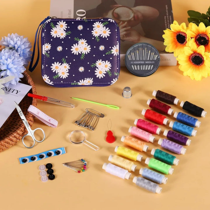 Purple Embroidery sewing kit with floral-patterned pouch, threads, scissors, and other tools on a yellow surface.