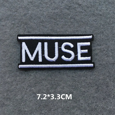 Embroidered patch with 'MUSE' text on a gray background