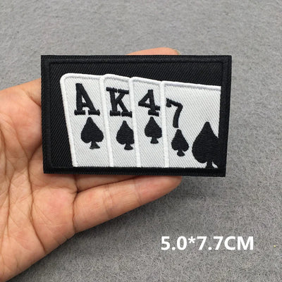 Card suit patch with 'AK47' on a gray background