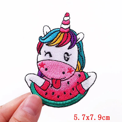 Unicorn with watermelon patch held by a hand on a white background