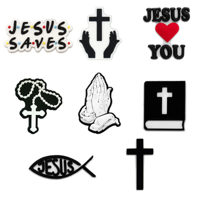Set of religious-themed shoe charms including 'Jesus Saves', cross, praying hands, Bible, fish symbol, and 'Jesus Loves You' with a heart.