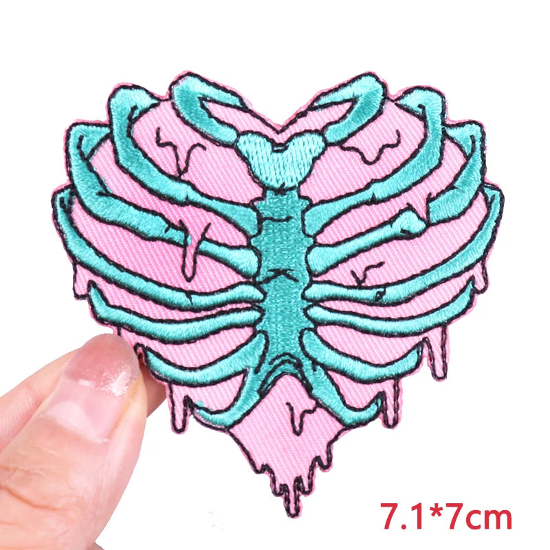 Pink and teal ribcage design patch held by a hand with size measurement '7.1*7cm' displayed.