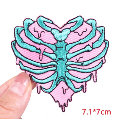 Pink and teal ribcage design patch held by a hand with size measurement '7.1*7cm' displayed.