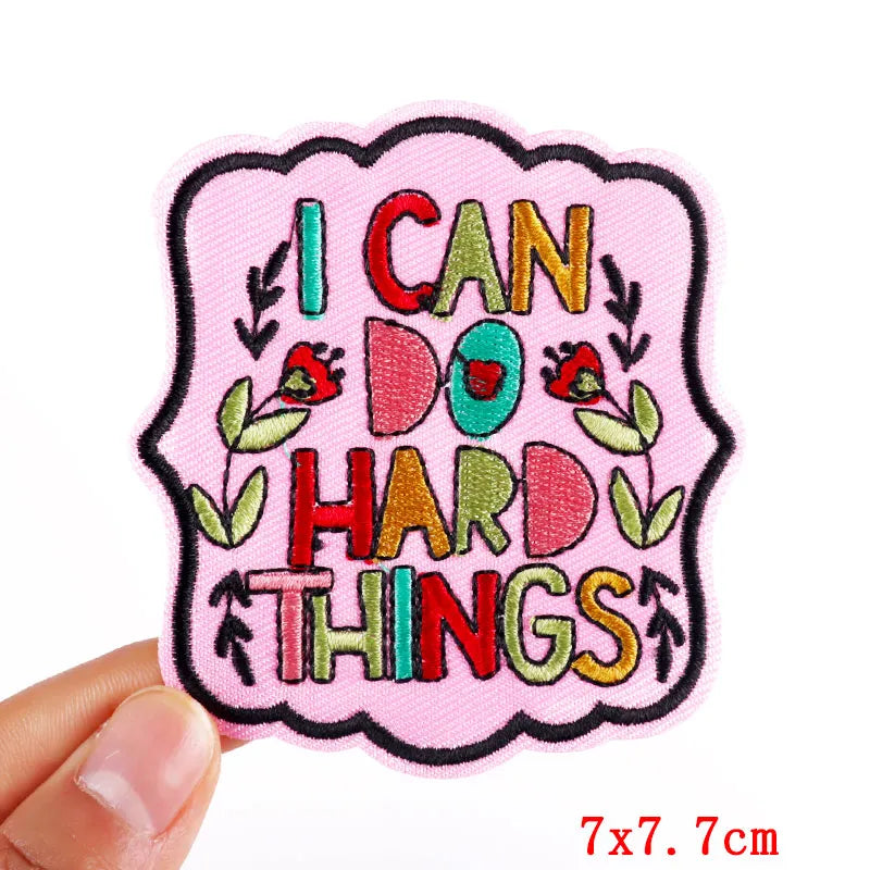 Motivational patch with 'I can do hard things' text held by a hand on a white background