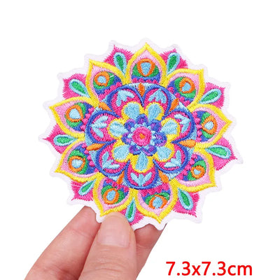 Colorful embroidered patch held by a hand with dimensions displayed