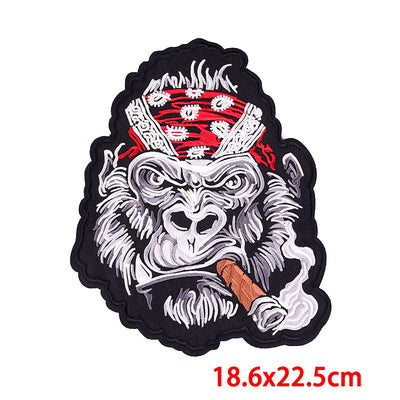 Embroidered patch of a monkey with a red headband and cigarette, size 18.6x22.5cm.