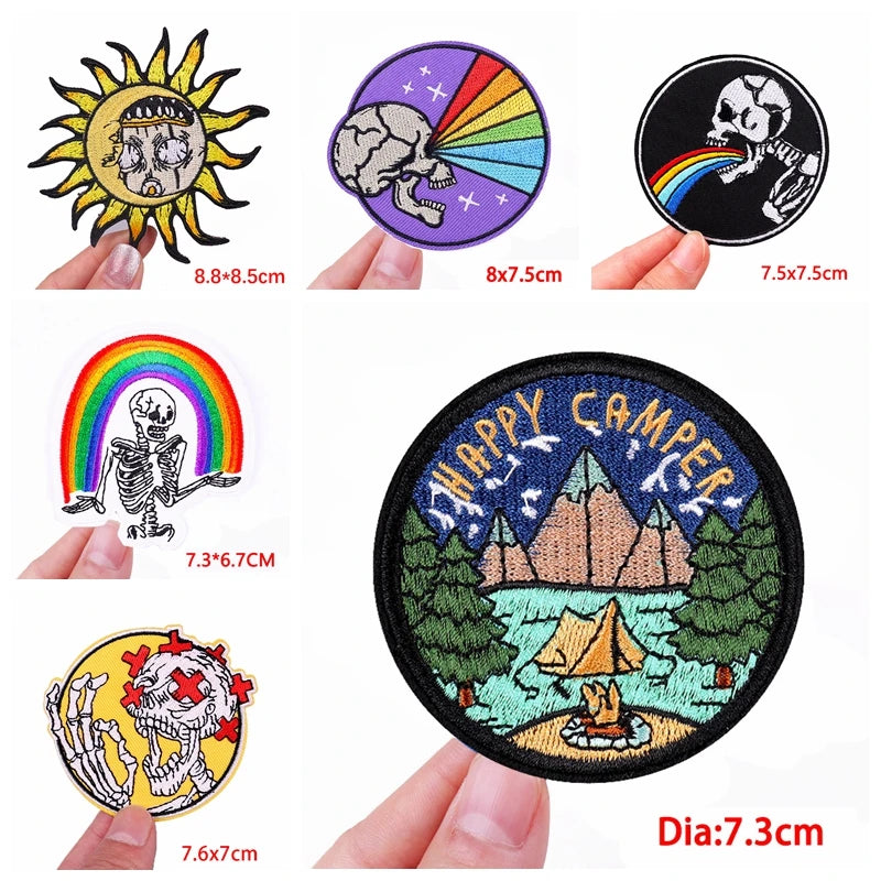 Collection of various patches with different designs and sizes, held by hands.
