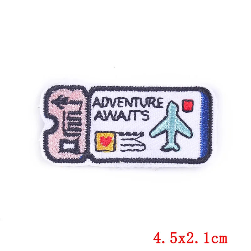 Embroidered patch with 'Adventure Awaits' text and airplane icon on a white background