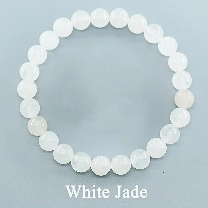 White jade beaded bracelet on a light blue background