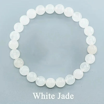 White jade beaded bracelet on a light blue background