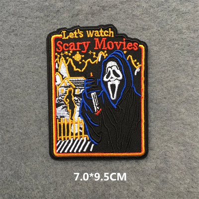 Embroidered patch with a ghostly figure and text 'Let's watch Scary Movies' on a gray background.