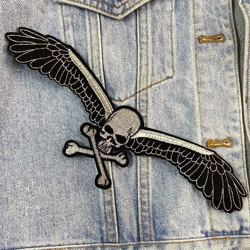 Denim jacket with a skull and wings patch