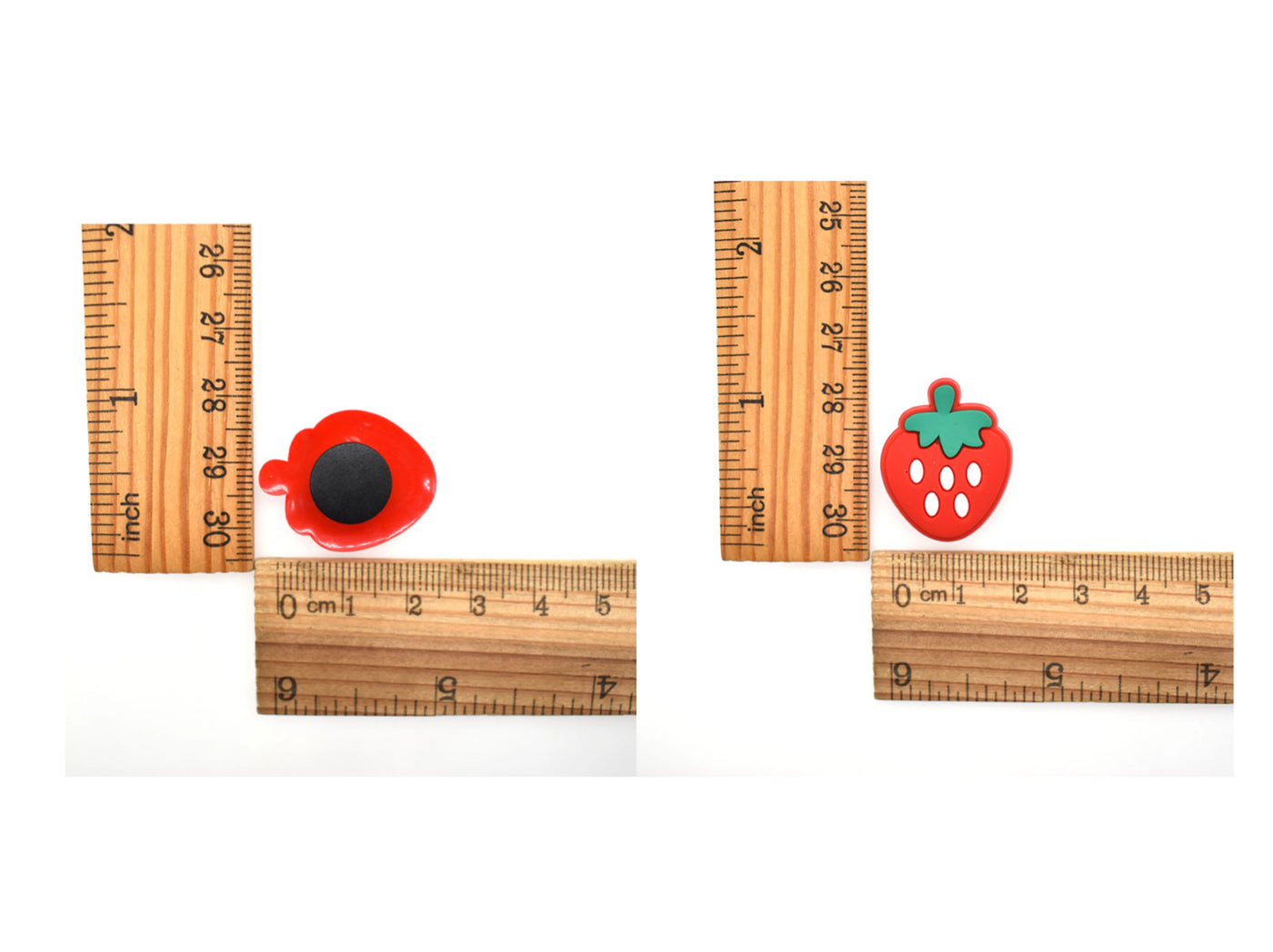 Wooden rulers with red and green shoe charms on a white background