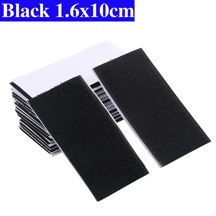 Black adhesive Velcro patches with dimensions 1.6x10cm on a white background