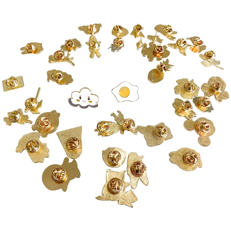 Collection of small gold earrings on a white background