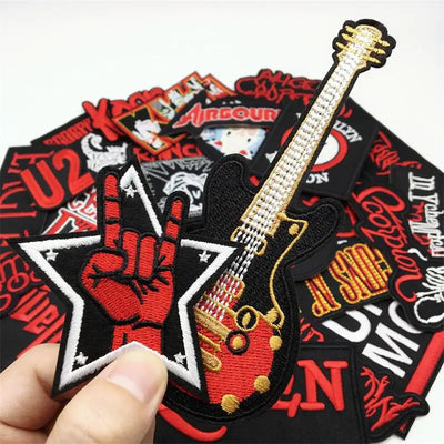 Collection of embroidered patches with musical instruments and band logos.