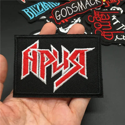 Patch with 'ATP' logo held in a hand, with other patches in the background.