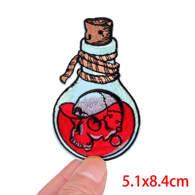 Embroidered patch of a bottle with a bear inside, held by a hand with measurement text '5.1x8.4cm'.