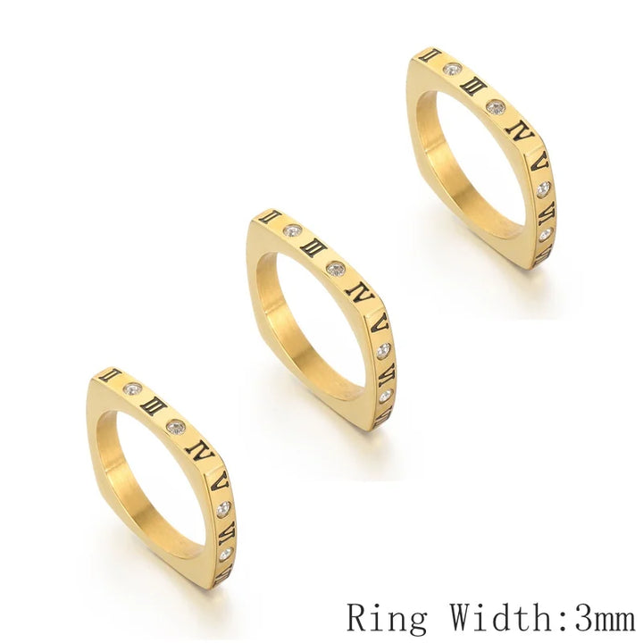 Three gold rings with Roman numeral design on a white background
