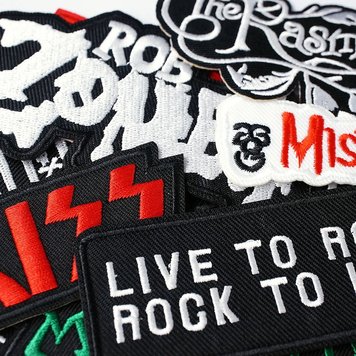 Collection of rock-themed patches with various designs and text.