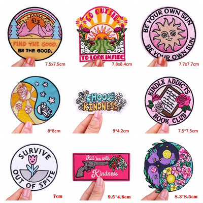 Collection of colorful stickers with various designs and text, held by hands.