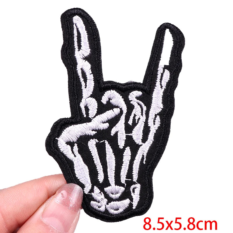 Handmade black and white skeleton hand patch held by a hand with measurement text '8.5x5.8cm'.