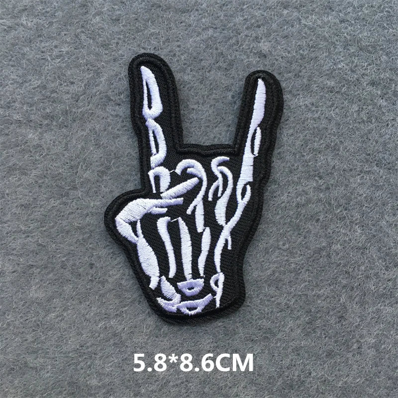 Skeleton hand making a peace sign patch on a gray background
