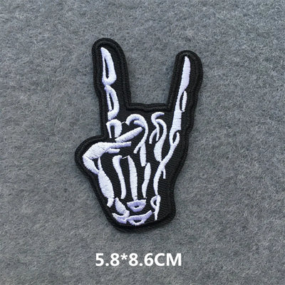 Skeleton hand making a peace sign patch on a gray background