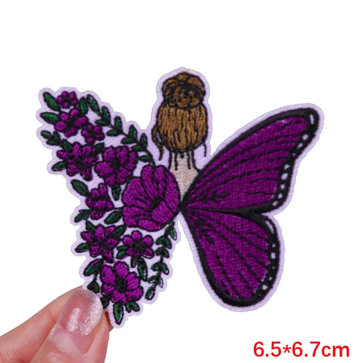Butterfly and flower patch held by a hand with dimensions displayed