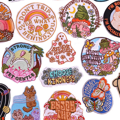 Collection of colorful embroidered patches with various designs and text.