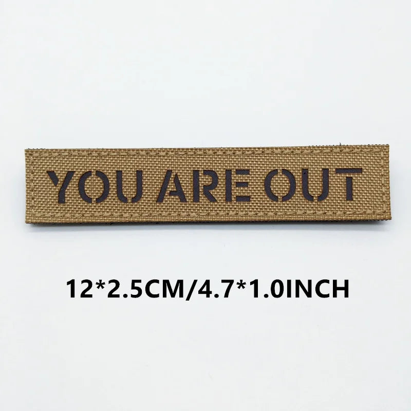 Brown patch with 'YOU ARE OUT' text on a white background