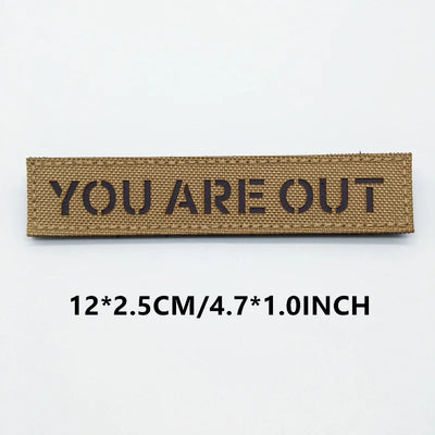 Brown patch with 'YOU ARE OUT' text on a white background